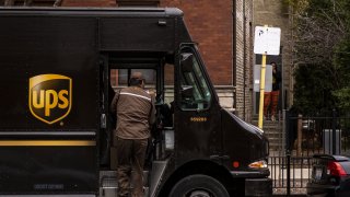 A United Parcel Service driver unloads package in the Lincoln Park neighborhood of Chicago, Illinois, U.S., on Monday, Nov. 30, 2020.