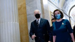 FILE - President Biden walks with House Speaker Nancy Pelosi of Calif., as he arrives on Capitol Hill in Washington, Oct. 28, 2021, for a meeting with House Democrats. Though its final shape is still being negotiated, Biden bowed to Democrats' handful of stubborn moderates demanding that he cut his 10-year, $3.5 trillion package of social and environment programs in half.