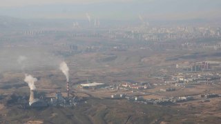 FILE - Smoke and steam rise from towers at the coal-fired Urumqi Thermal Power Plant in Urumqi in western China's Xinjiang Uyghur Autonomous Region on April 21, 2021. Global carbon pollution this year has bounced back to almost 2019 levels, after a drop during pandemic lockdowns. A new study by climate scientists at Global Carbon Project finds that the world is on track to put 36.4 billion metric tons of invisible carbon dioxide.
