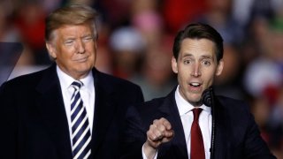 FILE - President Donald Trump listens as Republican Senate candidate Josh Hawley speaks during a campaign rally at Columbia Regional Airport, Thursday, Nov. 1, 2018, in Columbia, Mo. A federal lawsuit accuses the National Rifle Association of violating campaign finance laws by using shell companies to illegally funnel up to $35 million to Republican candidates, including former President Trump, Sen. Hawley of Missouri and others. The Campaign Legal Center filed the lawsuit Tuesday, Nov. 2, 2021, in Washington on behalf of Giffords, a gun control nonprofit founded by former Democratic U.S. Rep. Gabby Giffords.