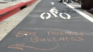 A note is shown on the pavement of a separated bikeway in Southern California.