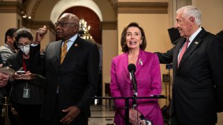 WASHINGTON, DC - NOVEMBER 05: (L-R) House Majority Whip Rep. James Clyburn (D-SC), Speaker of the House Nancy Pelosi (D-CA) and House Majority Leader Rep. Steny Hoyer (D-MD) speak to reporters on their way to the House Chamber at the U.S. Capitol November 05, 2021 in Washington, DC. Late on Friday night, the House passed the $1 trillion bipartisan infrastructure bill after months of negotiations.