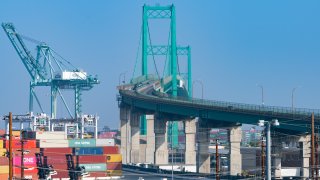 SAN PEDRO, CA – NOVEMBER 07: General views of shipping containers stacked at the Port of Los Angeles next to idle cargo transport trucks near the Vincent Thomas Bridge on November 07, 2021 in San Pedro, California. (Photo by AaronP/Bauer-Griffin/GC Images)