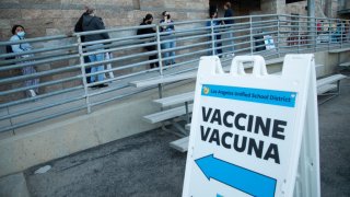 ARLETA, CA – NOVEMBER 08: Parents and children line up for COVID vaccine shots at Arleta High School on Monday, Nov. 8, 2021. With the recent Centers for Disease Control and Preventions approval of Pfizers COVID-19 vaccine for children ages 5 to 11, Los Angeles Unified will offer voluntary vaccine access to students. The district highly encourages the vaccine for children ages 5 to 11. However, it will not be part of Los Angeles Unifieds current student vaccine requirement. (Myung J. Chun / Los Angeles Times via Getty Images)