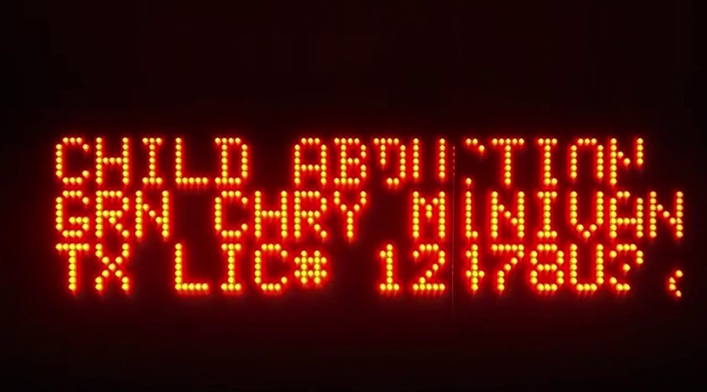 A freeway sign displays information about a minivan sought in connection with an Amber Alert.