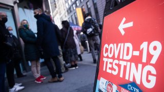 Residents wait in line at a Covid-19 mobile testing site in the Times Square neighborhood of New York, U.S., on Sunday, Dec. 5, 2021.