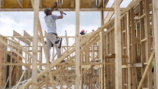 Construction workers frame a new home being built by CastleRock Communities in the Sunfield neighborhood of Buda, Texas, U.S., on Wednesday, Nov. 10, 2021.