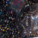 A crowd gathers at the spot where George Floyd was murdered at George Floyd Square after former Minneapolis police Officer Derek Chauvin was convicted of murder and manslaughter of Floyd, April 20, 2021, in Minneapolis.