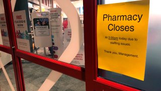 A sign is posted outside a CVS pharmacy on Thursday, Dec. 2, 2021 in Indianapolis