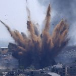 A blast from an Israeli airstrike on a building in Gaza City throws dust and debris on May 13, 2021, as Hamas and Israel traded more rockets and airstrikes and Jewish-Arab violence raged across Israel at the end of the Muslim holy month of Ramadan.