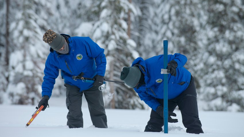 Anthony Burdock, left, and Sean de Guzman, chief of snow surveys for the California Department of Water Resources, check the depth of the snow pack during the first snow survey of the season at Phillips Station near Echo Summit, Calif., Thursday, Dec. 30, 2021. The survey found the snowpack at 78.5 inches deep with a water content of 20 inches. Statewide, the snow holds 160% of the water it normally does this time of year.