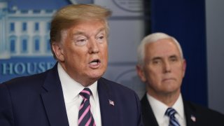 U.S. President Donald Trump speaks as Vice President Mike Pence listens during a news conference in the White House in Washington, D.C., U.S., on Friday, April 24, 2020. Trump has been determined to talk his way through the coronavirus crisis, but his frequent misstatements at his daily news conferences have caused a litany of public health and political headaches for the White House.