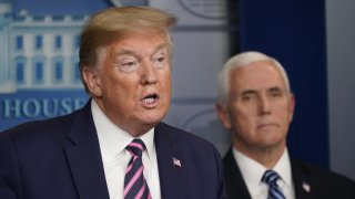 U.S. President Donald Trump speaks as Vice President Mike Pence listens during a news conference in the White House in Washington, D.C., U.S., on Friday, April 24, 2020. Trump has been determined to talk his way through the coronavirus crisis, but his frequent misstatements at his daily news conferences have caused a litany of public health and political headaches for the White House.
