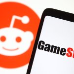A GameStop logo seen in front of Reddit logo. A Reddit community turned Wall Street upside down in January when users of r/WallStreetBets created a short squeeze with the gaming retailer's stocks.