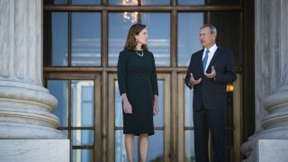 Amy Coney Barrett, associate justice of the U.S. Supreme Court, left, and Chief Justice John Roberts