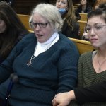 From left: Kariann Swart, Joseph Rosenbaum's fiancee; Susan Hughes, Anthony Huber's great aunt; and Hannah Gittings, Anthony Huber's girlfriend, listen as Kyle Rittenhouse is found not guilty at the Kenosha County Courthouse on Nov. 19, 2021 in Kenosha, Wisconsin.