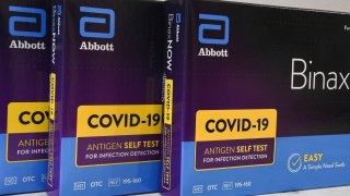 In this photo illustration, the Abbott’s at-home COVID-19 rapid test kits are seen on display in Orlando, Florida.