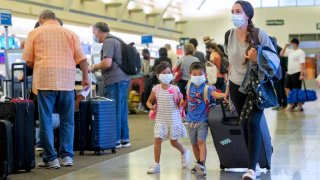 Santa Ana, CA – June 30: Travelers head to check-in at John Wayne Airport in Santa Ana, CA on Wednesday, June 30, 2021. Free from most of the COVID-19 restrictions, many people are traveling and taking advantage of the long July 4th weekend. (Photo by Paul Bersebach/MediaNews Group/Orange County Register via Getty Images)
