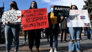 Demonstrators holding signs