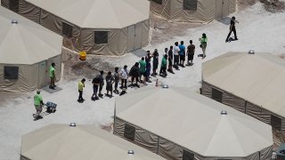 TORNILLO, TX - JUNE 19: Children and workers are seen at a tent encampment recently built near the Tornillo Port of Entry on June 19, 2018 in Tornillo, Texas. The Trump administration is using the Tornillo tent facility to house immigrant children separated from their parents after they were caught entering the U.S. under the administration's zero tolerance policy.