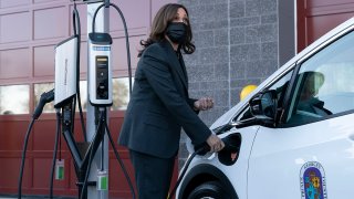 Vice President Kamala Harris charges an electric vehicle in one of the charging stations during her tour of the Brandywine Maintenance Facility in Prince George's County, Md., Dec. 13, 2021.
