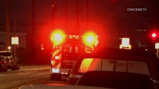 An ambulance leaves an Anaheim neighborhood.