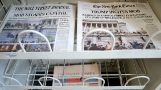 newspaper headlines show the breach of the U.S. Capitol