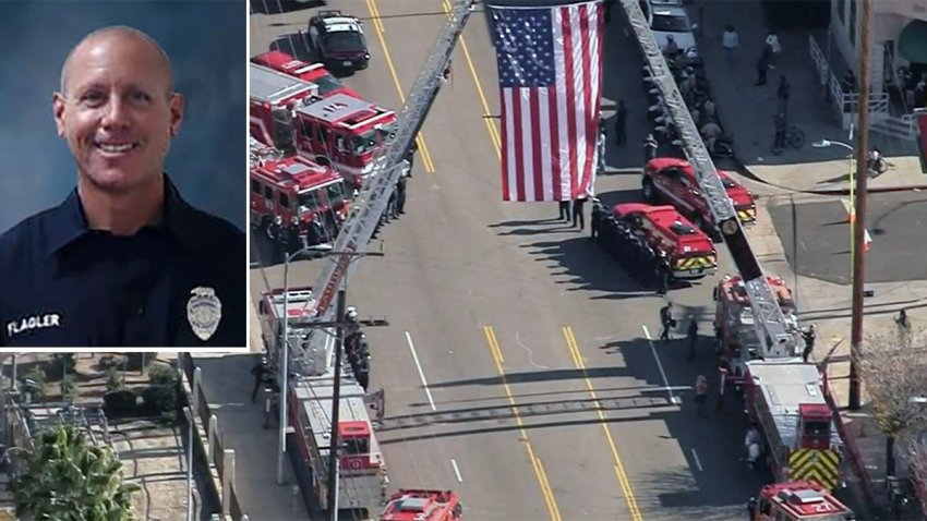 A procession for firefighter Jonathan Flagler (inset) arrives at the medical examiner's office .