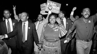 John Lewis, left, and his wife, Lillian, lead a march of supporters from his campaign headquarters to an Atlanta hotel