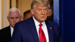 President Donald Trump, followed by Vice President Mike Pence, left, walks into the briefing room at the White House in Washington, Tuesday, Nov. 24, 2020, to make a statement.