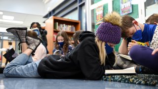 5th graders are reading books at the library