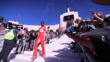 Los Angeles, CA - February 06: NASCAR racer Bubba Wallace walks down the staircase to the track as he is introduced and cheered by fans at the Busch Light Clash At The Coliseum, a NASCAR exhibition race at the historic LA Memorial Coliseum in Los Angeles Sunday, Feb. 6, 2022. Joey Logano, #22, went on to win the race. The season-opening Clash exhibition race gets a taste of West Coast flavor in 2022, marking a historic first visit to the tradition-rich Los Angeles Memorial Coliseum. The event is to be contested around a quarter-mile asphalt oval that will be built around the facilitys football field. The Los Angeles event marks the first time the preseason Clash is held outside of Daytona International Speedway since its inception in 1979, and gives the sport its first competitive look at the Next Gen car on Feb. 6 in a non-points event, including a pre-race concert by Pit Bull and Ice Cube. (Allen J. Schaben / Los Angeles Times via Getty Images)