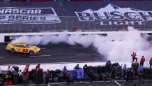 Los Angeles, CA - February 06: NASCAR driver Joey Logano, #22, does a celebratory burn-out to honor his pit crew as they cheer him on after he won the Busch Light Clash At The Coliseum, a NASCAR exhibition race Sunday, Feb. 6, 2022. The season-opening Clash exhibition race gets a taste of West Coast flavor in 2022, marking a historic first visit to the tradition-rich Los Angeles Memorial Coliseum. The event is to be contested around a quarter-mile asphalt oval that will be built around the facilitys football field. The Los Angeles event marks the first time the preseason Clash is held outside of Daytona International Speedway since its inception in 1979, and gives the sport its first competitive look at the Next Gen car on Feb. 6 in a non-points event, including a pre-race concert by Pit Bull. Photo taken at LA Memorial Coliseum on Sunday, Feb. 6, 2022 in Los Angeles, CA. (Allen J. Schaben / Los Angeles Times via Getty Images)