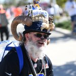 A Rams fan with a highly decorated hat poses