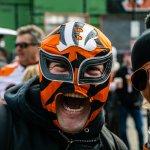 A masked Bengal fan looks on