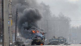 Russian armored personnel carrier burning in Kharkiv