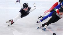 Kristen Santos of Team USA overtakes Petra Jaszapati of Team Hungary and Cynthia Mascitto of Team Italy in the middle of the women's 1000m Heats at the 2022 Winter Olympics, Feb. 9, 2022, in Beijing, China.