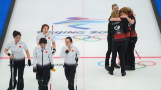 Yu Han, Tui Wang, Ziqi Dong, KLijun Zhang of Team China leaves as Madeleine Dupont, My Larsen, Mathilde Halse and Denis Dupont of Team Denmark celebrate after winning their Women's Round Robin Session at the National Aquatics Centre on Feb. 10, 2022, in Beijing.