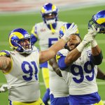 Aaron Donald #99 and Greg Gaines #91 of the Los Angeles Rams react