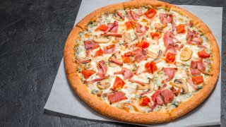 fresh pizza with mushrooms and ham