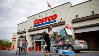 Shoppers wearing face masks leave a Costco wholesale store in Washington, D.C.