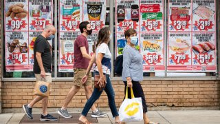 People wear face masks outside a supermarket on the Upper West Side in New York City.