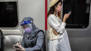 Commuters on a train in Hong Kong on March 2, 2022, amid the Covid pandemic.