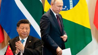 Chinese President Xi Jinping and Russian President Vladimir Putin attend a meeting during the BRICS (Brazil, Russia, India, China, and South Africa) summit in Brasilia on November 14, 2019.