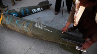 FILE - A man displays an American-made CBU 58A/B cluster bomb in a police compound in Sanaa, Yemen, on Oct. 5, 2016.