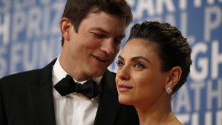 actor Mila Kunis poses for a picture with her husband actress Ashton Kutcher
