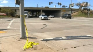 Unraveled police crime scene tape at the intersection where a woman was shot and killed in Commerce.