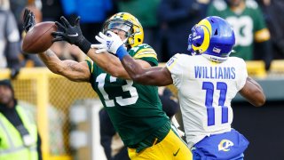 Green Bay Packers wide receiver Allen Lazard (13) tries unsuccessfully to catch a pass as Los Angeles Rams cornerback Darious Williams (11) defends during the first quarter at Lambeau Field.