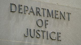 File photo showing a sign outside the Robert F. Kennedy Department of Justice building in Washington.