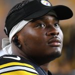 Dwayne Haskins wearing a Steelers uniform and hat